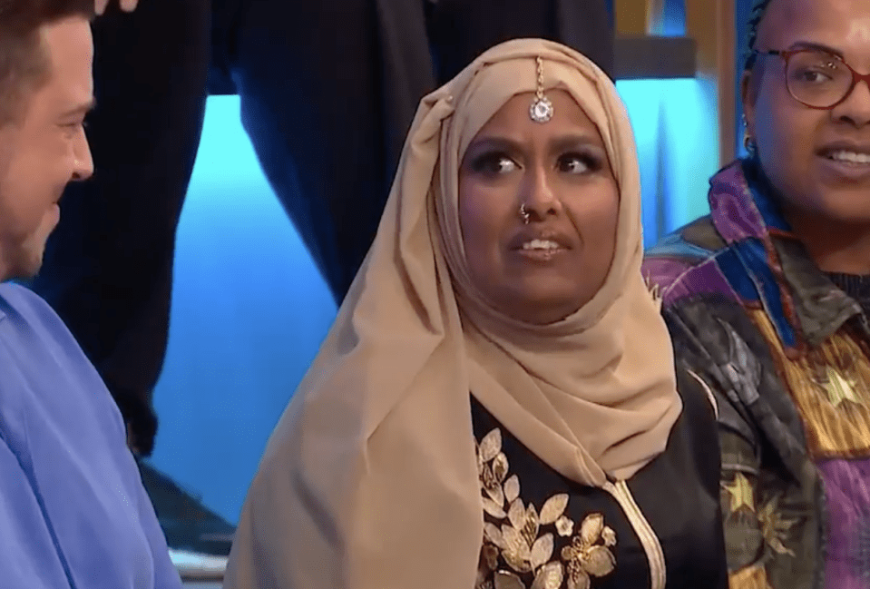 Farida from Big Brother wearing a hijab, looking surprised.