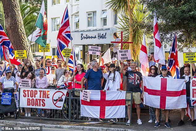 According to latest figures the Home Office is supporting 103,000 migrants including just over 32,000 in hotels (Pictured: Protestors outside the Britannia Hotel in Bournemouth in September)