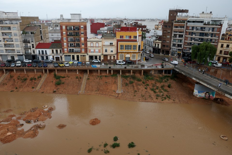 Aerial view of the Poyo ravine overflowing with muddy water after heavy rainfall in Paiporta, near Valencia, Spain.