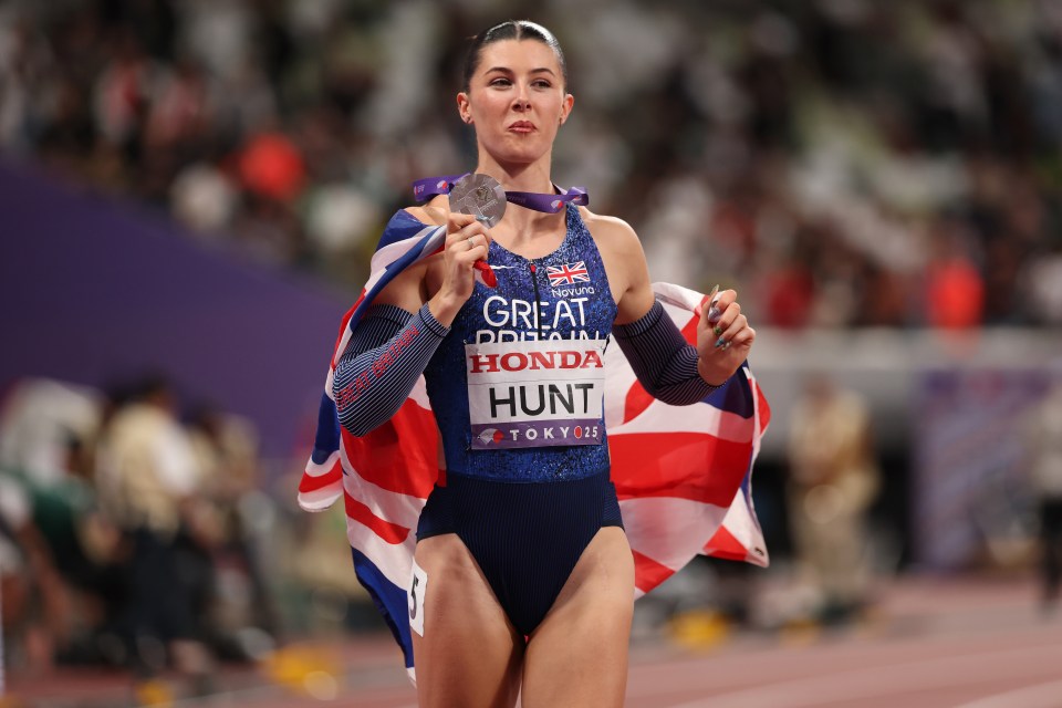 Amy Hunt of Great Britain holding a silver medal and British flag after winning the silver in the Women's 200 metres final at the World Athletics Championships.