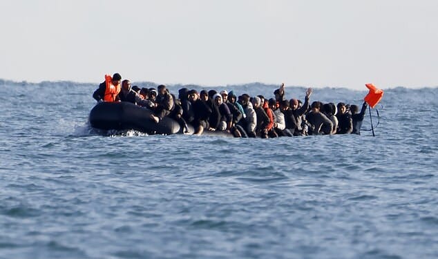 Migrants cross the Channel from northern France aboard a 40ft 'mega dinghy' last month