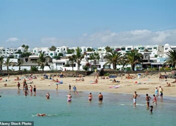 A British tourist has died in Lanzarote after plunging nearly 20ft when the railing of a hotel balcony reportedly gave way. File photo: Tourists enjoy a beach day in the resort town of Costa Teguise in Lanzarote, where the incident unfolded