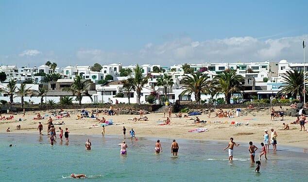 A British tourist has died in Lanzarote after plunging nearly 20ft when the railing of a hotel balcony reportedly gave way. File photo: Tourists enjoy a beach day in the resort town of Costa Teguise in Lanzarote, where the incident unfolded