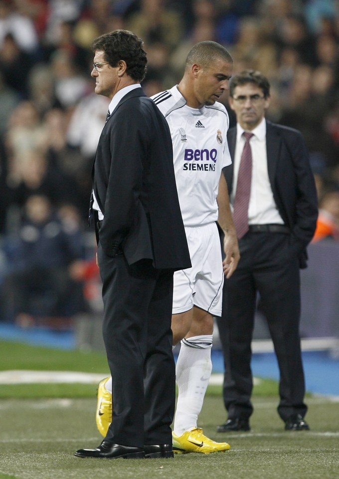 Fabio Capello stands beside Ronaldo on the field during a Real Madrid vs. Celta de Vigo match.