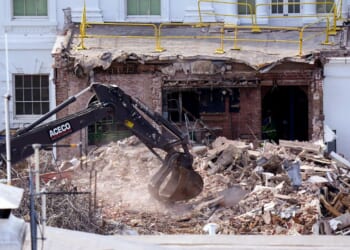An excavator works to clear rubble after the East Wing of the White House was demolished on Thursday.
