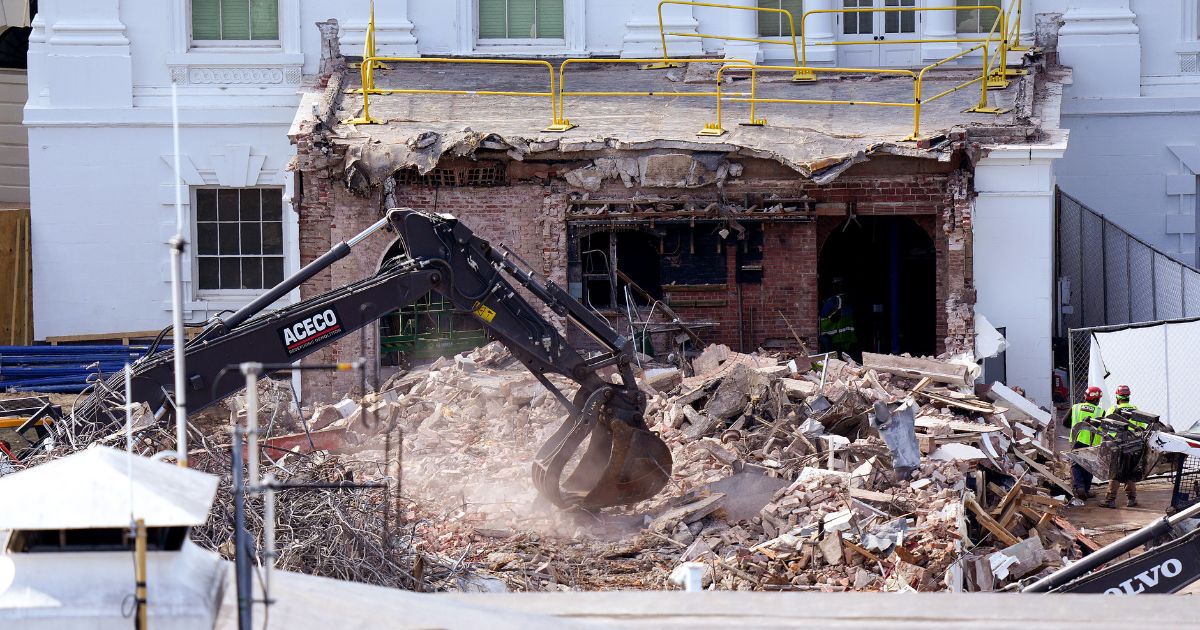 An excavator works to clear rubble after the East Wing of the White House was demolished on Thursday.