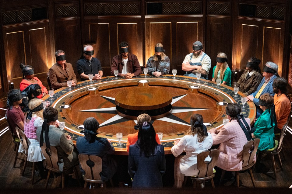 Contestants blindfolded at a round table.