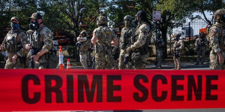 Federal law enforcement agents are confronted and surrounded by far-left protesters in the Brighton Park neighborhood of Broadview, Illinois, on Saturday.