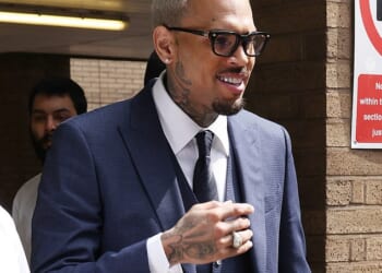 Chris Brown is allowed to return to the US on bail after being charged over an alleged unprovoked attack on a music producer in a London nightclub (Pictured: Brown attending Southward Crown Court in May this year)