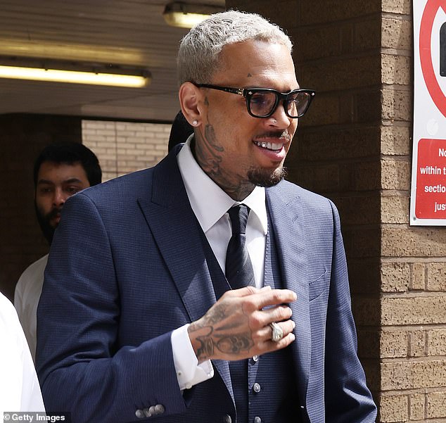 Chris Brown is allowed to return to the US on bail after being charged over an alleged unprovoked attack on a music producer in a London nightclub (Pictured: Brown attending Southward Crown Court in May this year)
