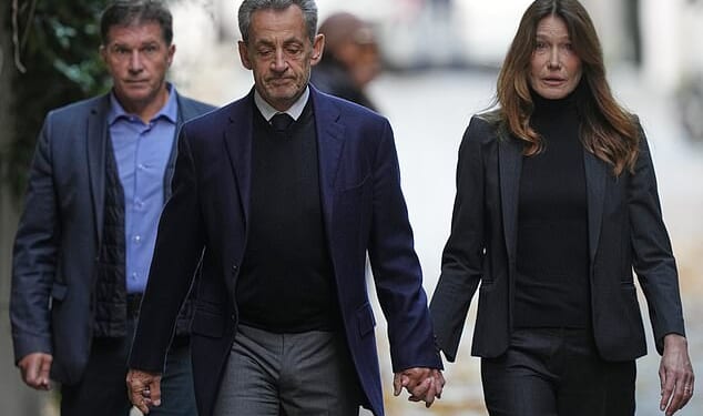 Former French President Nicolas Sarkozy and his wife Carla Bruni-Sarkozy leave their Paris home on Tuesday as Nicolas Sarkozy heads to prison to serve time for a criminal conspiracy to finance his 2007 election campaign with funds from Libya