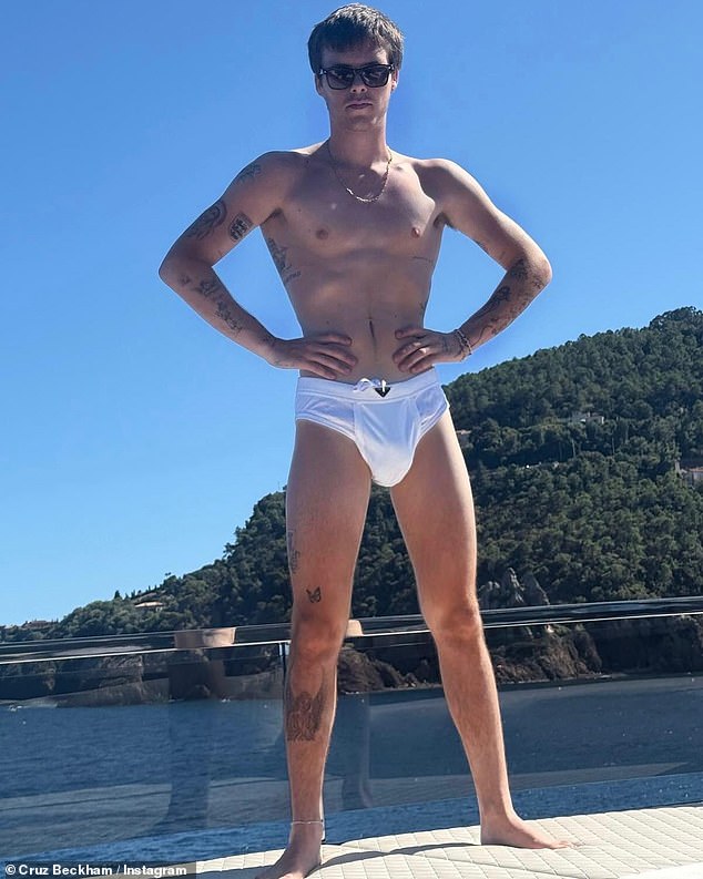 Cruz Beckham, 20, risks an embarrassing explanation with his posh parents after listening to his very explicit new single Optics which centres around drugs and sex (pictured this summer)