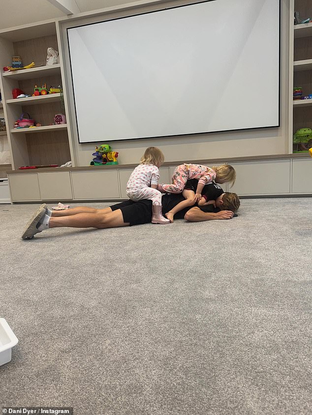 One fun photo showed the children climbing on Jarrod as he laid on the floor