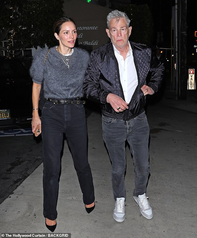 The silver fox, who was once linked to Christie Brinkley, was with his much-younger wife, actress Katharine McPhee, 41. She had her hair pulled back as she wore a gray sweater tucked into her belted black jeans