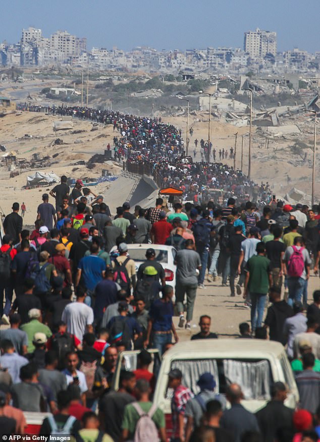 Palestinians, carrying the belongings they managed to take with them, move toward the northern part of the Gaza Strip