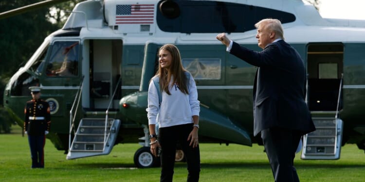 President Donald Trump and his granddaughter, Kai Trump, walk to Marine One on the South Lawn of the White House as they prepare to depart on Sept. 26, 2025, in Washington, D.C.