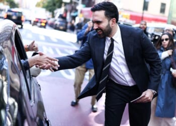 Democratic socialist candidate Zohran Mamdani greets people on the street Monday in the Manhattan borough of New York City during early voting for the upcoming mayoral election.