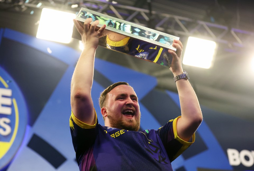 Luke Littler celebrating with the Boyle Sports World Grand Prix trophy.