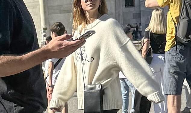 Emma Watson looked carefree on holiday with a handsome male companion in Pisa on Friday - as she brushed off JK Rowling's recent comments about her 'ignorance' regarding trans rights