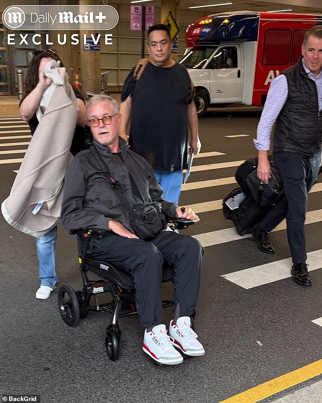 The acclaimed actor, 52, who first revealed he had been diagnosed with the incurable neurological condition in April, looked frail as he was pushed out of an airport by an aide