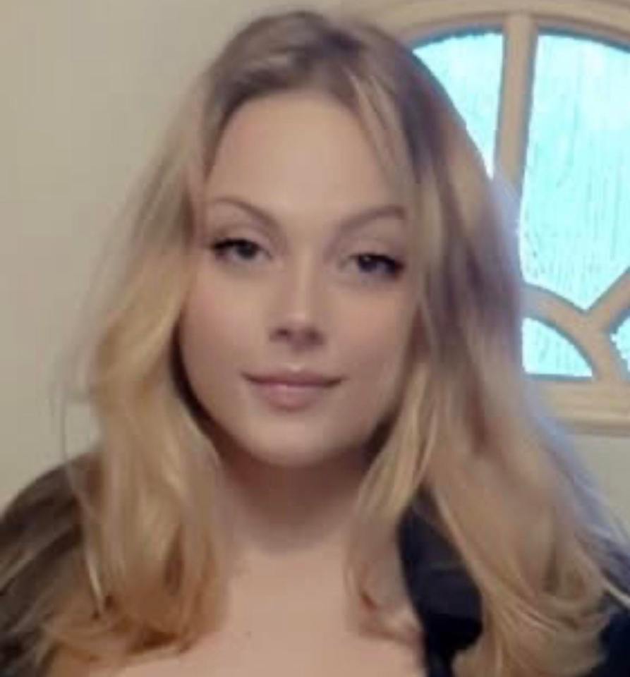 Photo of a young woman with long blonde hair, looking directly at the camera.