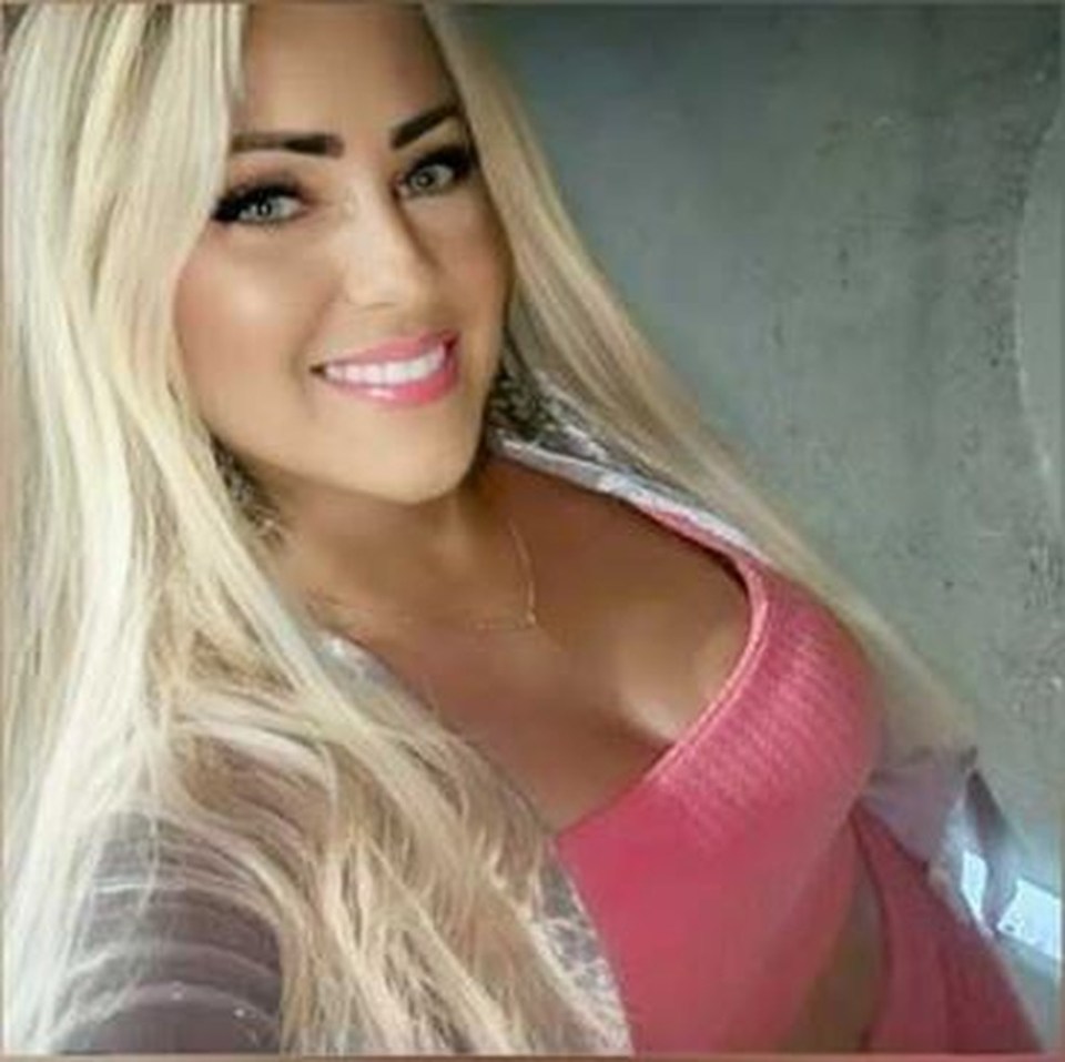 Woman with long blonde hair, smiling.