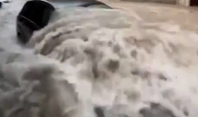 Cars floated down village streets and water engulfed vehicles