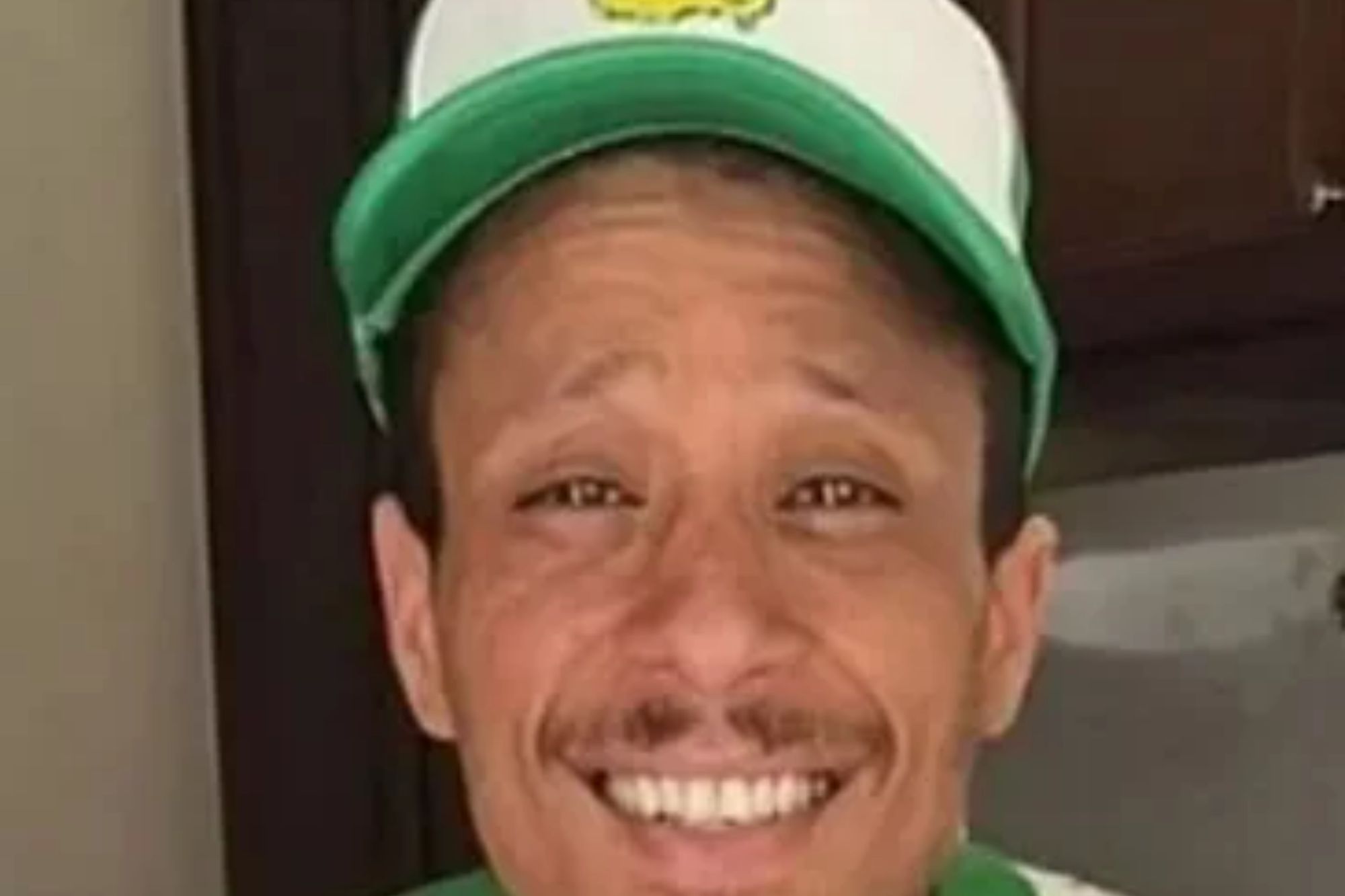 An image collage containing 1 images, Image 1 shows Floyd Roger Myers Jr. smiling and wearing a green and white Masters hat and a colorful Kenzo sweater