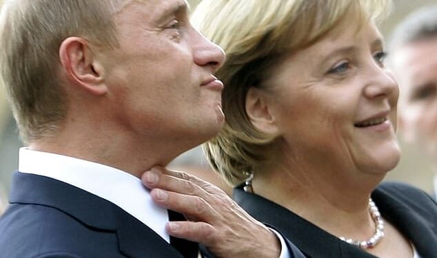 German Chancellor Angela Merkel (R) stands with Russian President Vladimir Putin prior to the two-day 'German-Russian Petersburg Dialogue' conference in the city of Dresden October 10, 2006