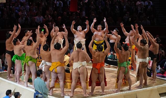 Sumo wrestlers are pictured celebrating the opening the sacred sumo wrestling ring during the Grand Sumo Tournament at the Royal Albert Hall on October 15