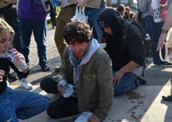Demonstrators protesting outside the U.S Immigration & Customs Enforcement facility, including Democratic congressional candidate Kat Abughazaleh, 26, left, react after being tear-gassed on Sept. 19, 2025, in Broadview, Illinois.