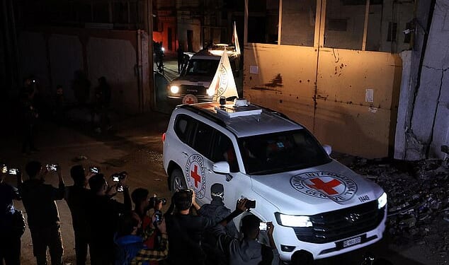 Red Cross vehicles transport the bodies of deceased hostages who had been held in Gaza since the deadly October 7, 2023 attack, after they were handed over by Hamas militants as part of a ceasefire and a hostages-prisoners swap deal between Hamas and Israel, in Gaza City, October 14, 2025