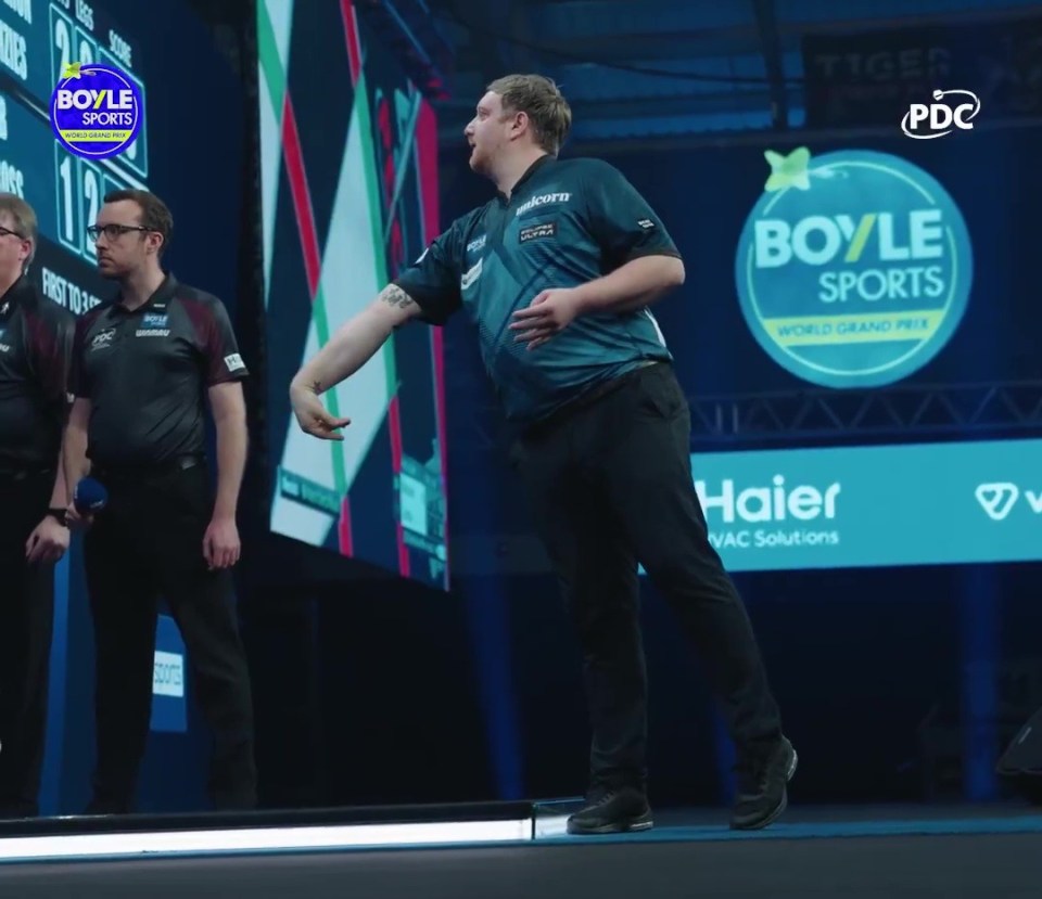 Cameron Menzies throwing a dart during the World Grand Prix.