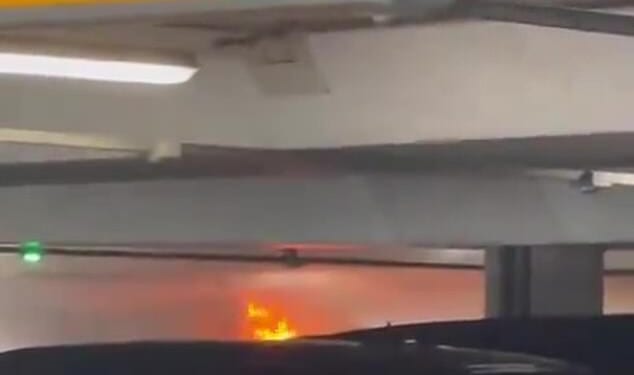 Striking footage show plumes of smoke billow out of the car park and bright orange flames burn through the building
