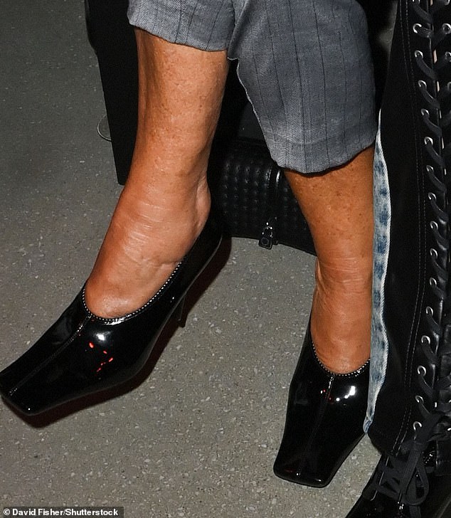 When she sat down, the star revealed her incredibly bronzed ankles as she sported a deep fake tan which contrasted the pale complexion of her face