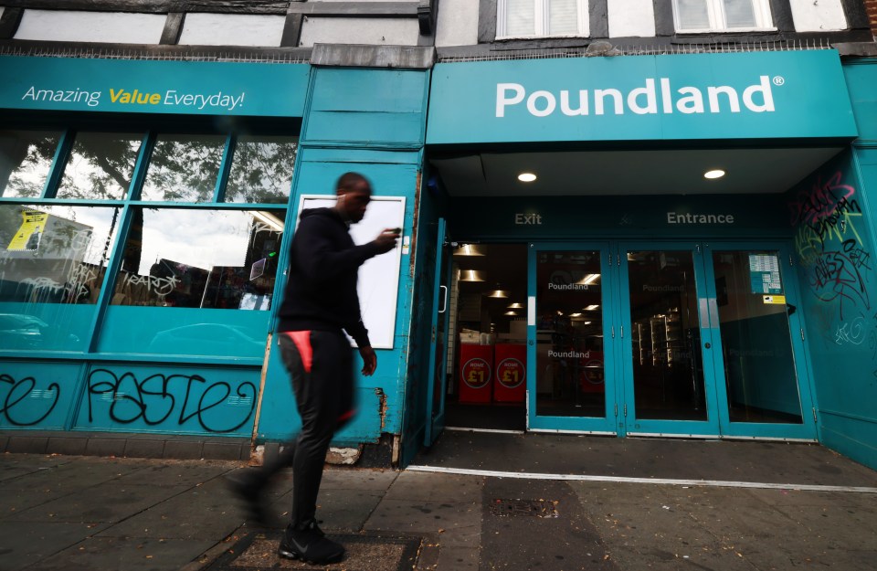 A person walking past a Poundland store.