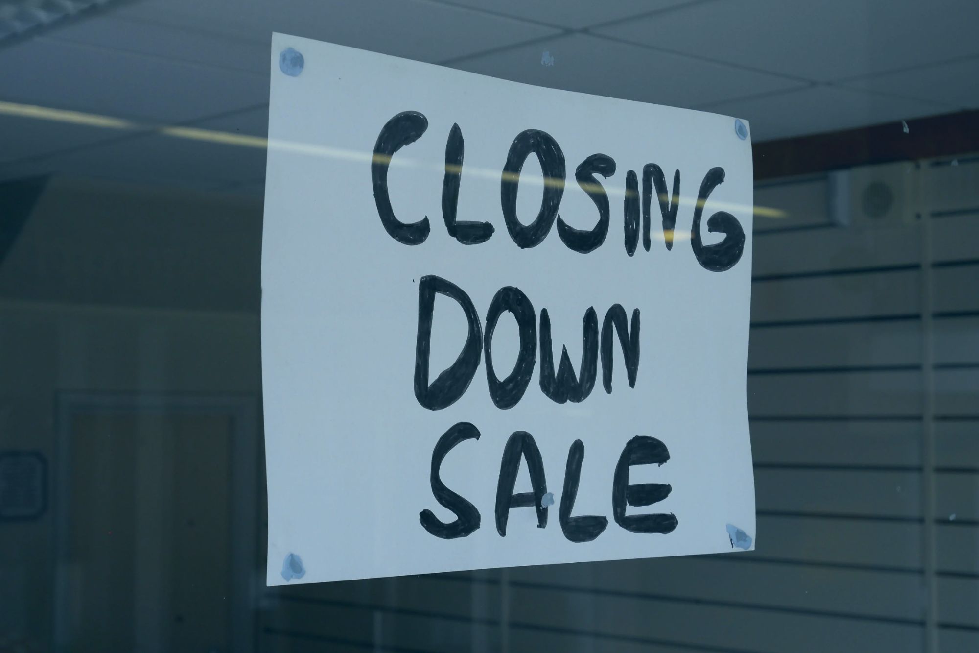 An image collage containing 1 images, Image 1 shows "Closing Down Sale" sign in the window of a closed retail business in Paignton, Devon, UK