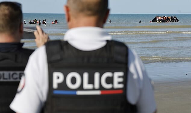 Britain's border security commander Martin Hewitt admitted to the Commons home affairs select committee the small size of the team dedicated to working on the deal. Pictured: French police officers take photos of migrants boarding a small boat to Britain from France on September 19, 2025