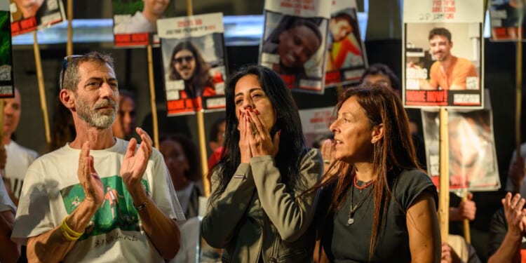 Einav Zangauker, mother of hostage Matan Zangauker, Ayelet Samerano, Ilan Dalal, father of hostage Guy Gilboa Dalal, stand on stage at a rally in Tel Aviv on October 11, 2025.