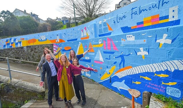 Holly Astle (centre, with the mural), an illustrator from Falmouth, Cornwall, accused the local council of whitewashing her art on a wall at the Lawn Steps in her hometown for 'political' reasons