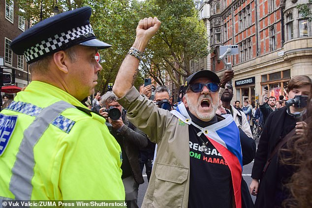 An Israel supporter stages a counter-protest as pro-Palestine students protest outside University College London on October 7 2025