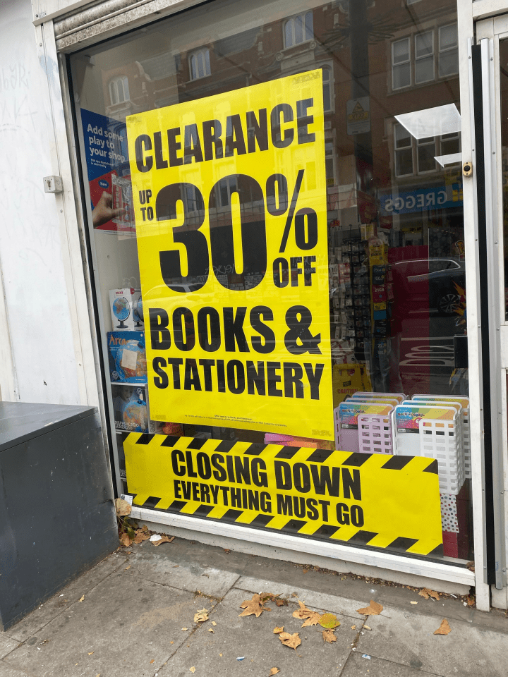Yellow and black "Clearance Up To 30% Off Books & Stationery" and "Closing Down Everything Must Go" signs in a shop window.
