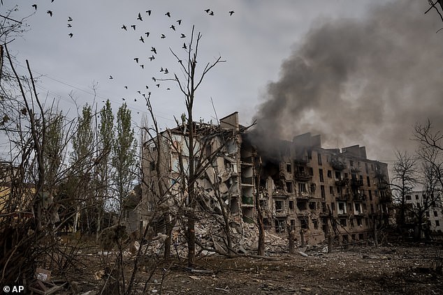 In this photo taken on Oct.13, 2025 and provided by Ukraine's 24th Mechanized Brigade press service, crows fly over the ruins and smoke in Kostiantynivka, a frontline town