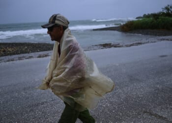 A man walks in the rain Tuesday before the arrival of Hurricane Melissa in Canizo, a community in Santiago de Cuba.