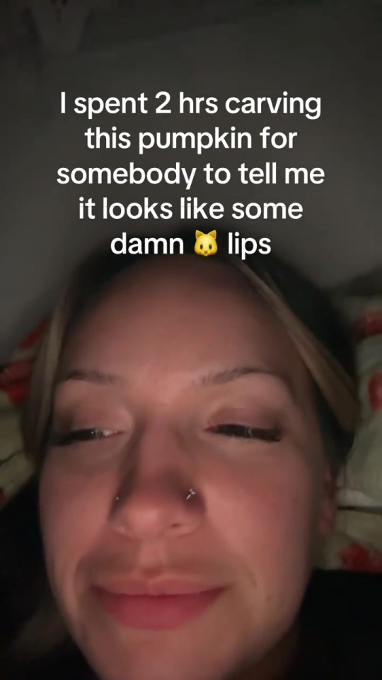 A woman with blonde hair, nose piercings, and a text overlay reading, "I spent 2 hrs carving this pumpkin for somebody to tell me it looks like some damn 😼 lips."