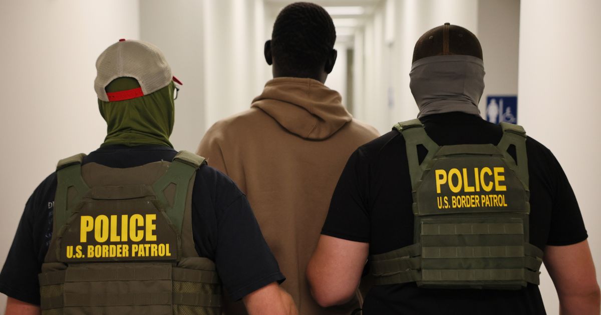 Federal agents detain a man after his court hearing in immigration court at the Ted Weiss Federal Building in New York City on July 9.