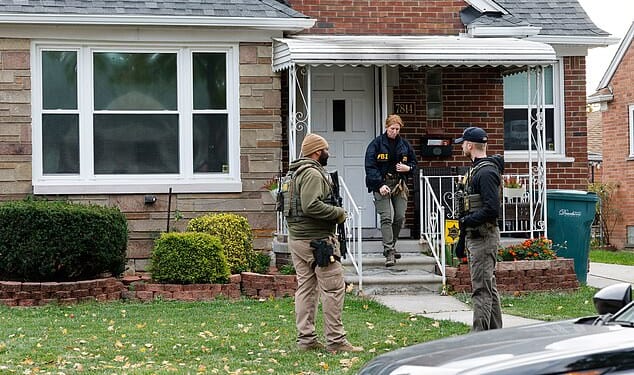 Members of the FBI Joint Terrorism Task Force search a home in Dearborn, Michigan, on Friday