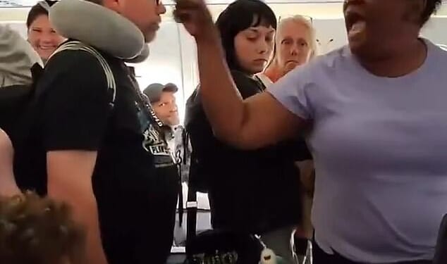 The entitled passenger (right) yelled at the crowd of people eager to get off the plane as she refused to move