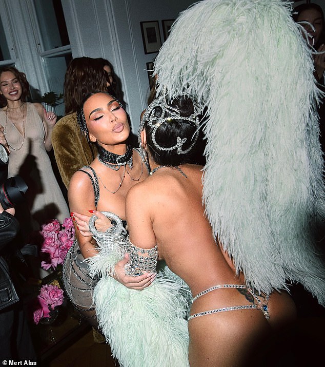 During the star-studded affair in the capital city, Kim was seen kissing a topless performer dressed in a bejewelled thong and feathered headdress