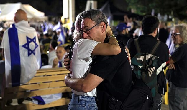 People embrace while waiting for the start of the hostage release live stream at Hostages Square on October 13, 2025 in Tel Aviv, Israel